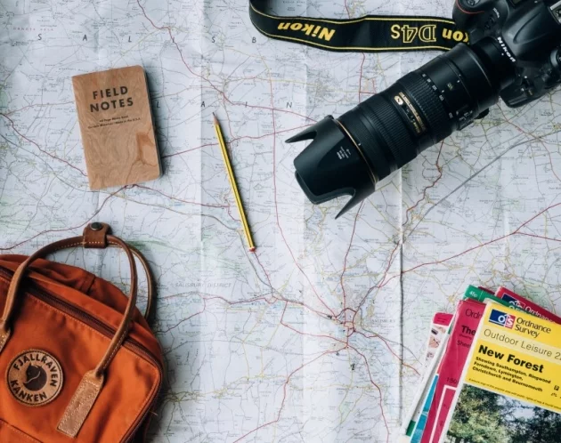 setting up a travel blog with a map, camera, notes and guides