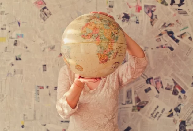 a girl looking around the globe